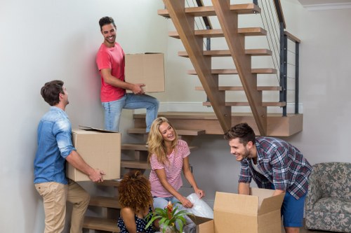 Movers unloading furniture and boxes at a Tower Hill property
