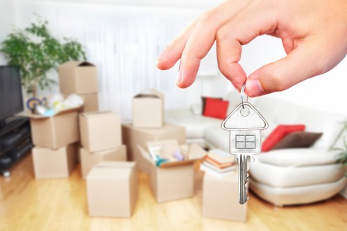 Movers handling office equipment and desks during a commercial relocation
