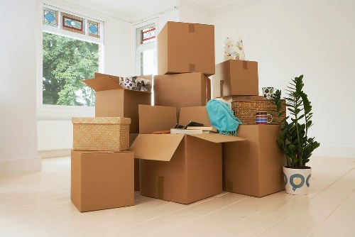 Removal team handling boxes and furniture in a Tower Hill flat move